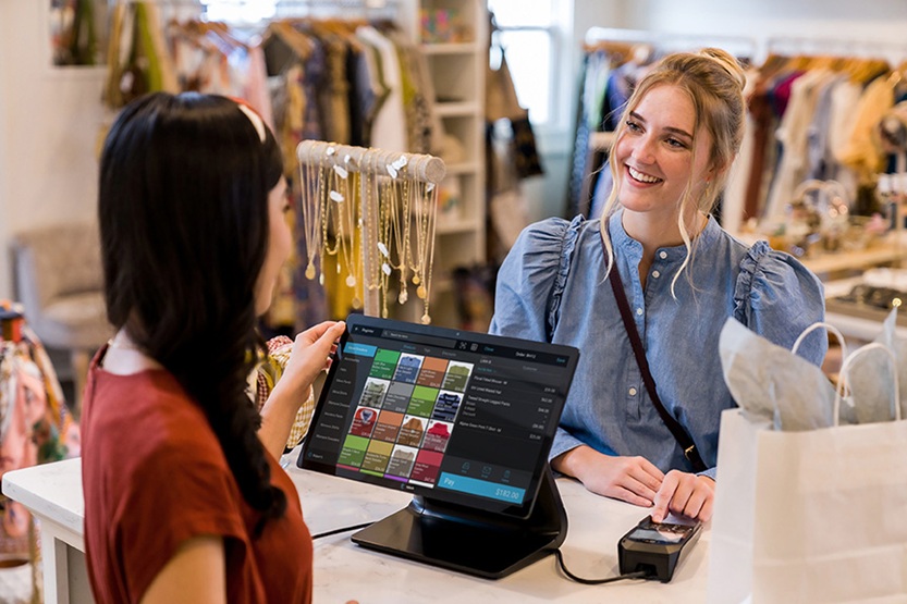 Woman checking out a payment terminal
